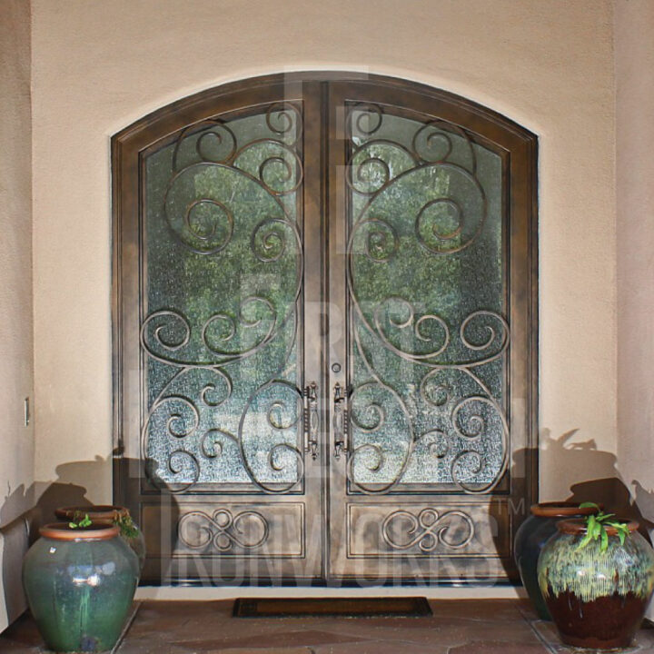 Iron and glass arched french entry doors with ornate scroll work design