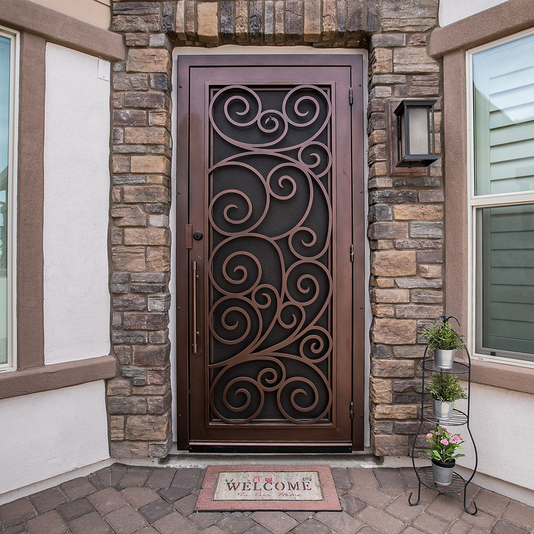 beautiful brown iron screen door with scrollwork details