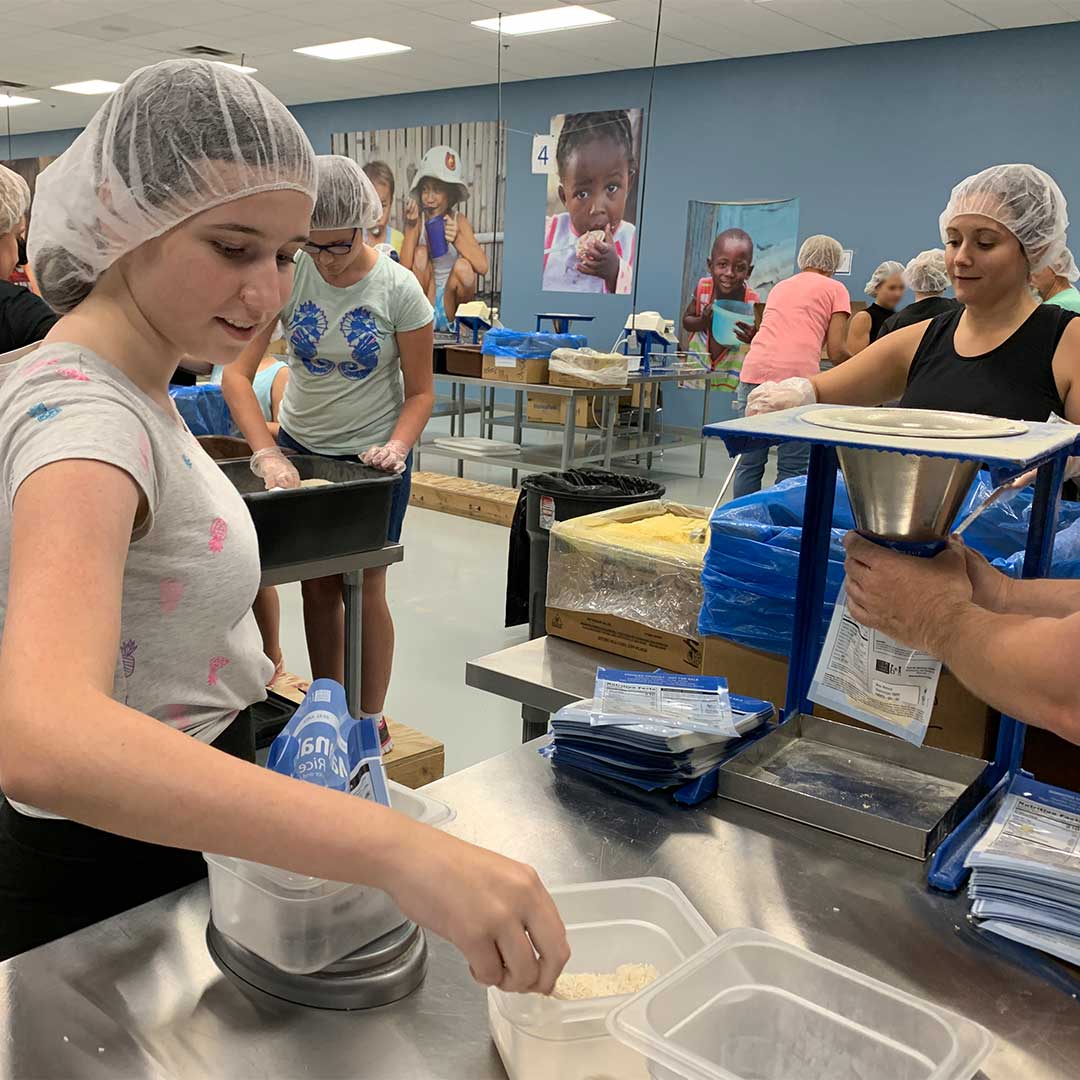 First Impressions Ironworks Employees Preparing Meals at Feed My Starving Children
