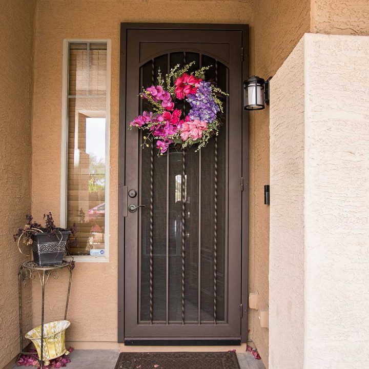 Available to ship nationwide is our Royale iron security door with wreath hanging on it