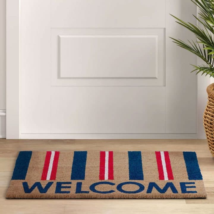 Patriotic Doormat on the ground in front of a door. Our doors can be delivered nationwide.