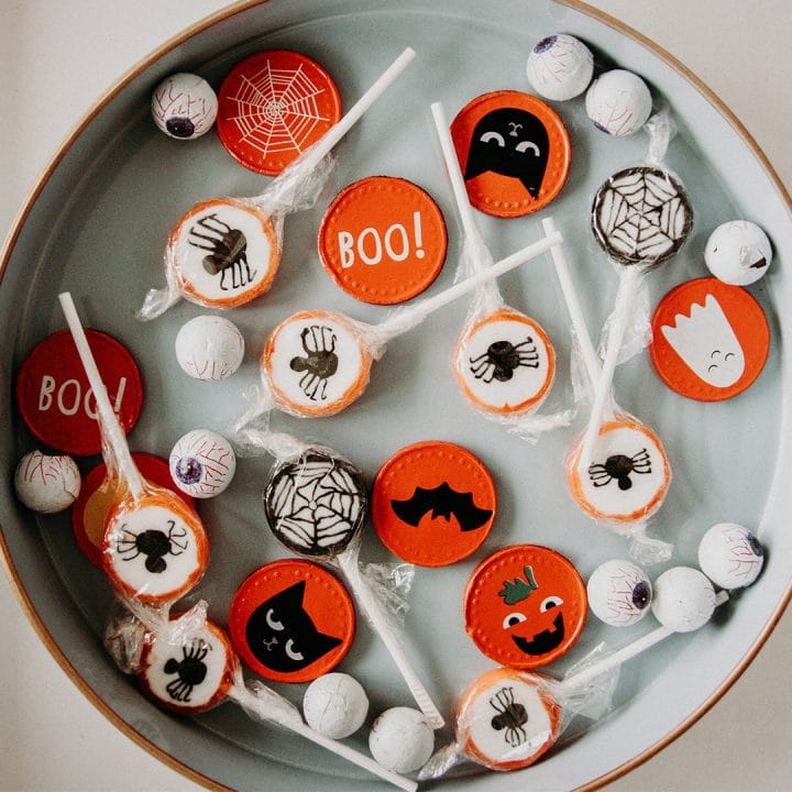 Halloween candy scattered on a round white platter