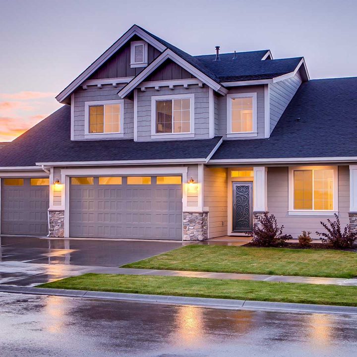 front of a suburban home with grass in the front yard and a First Impression Ironworks steel security front door