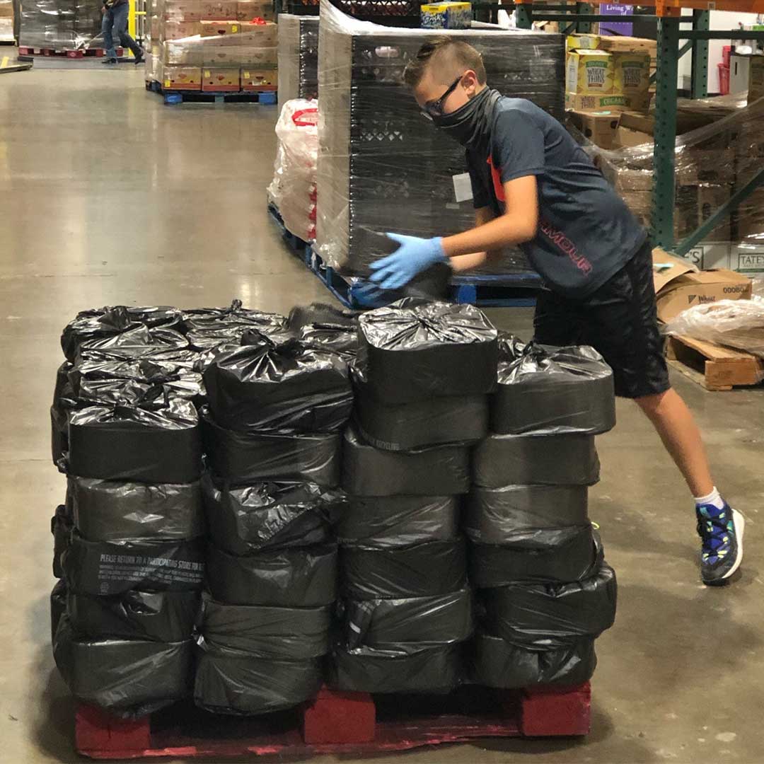 Volunteer loading supplies on a palette