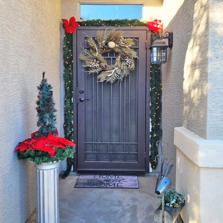 1st Impression Ironworks iron security door, with holiday wreath and garland.  Our doors are available for nationwide shipping.