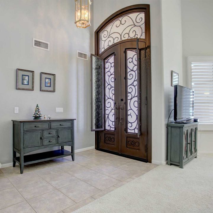 Inside the entryway of a home with large iron and glass French doors which can be shipped directly to your home.