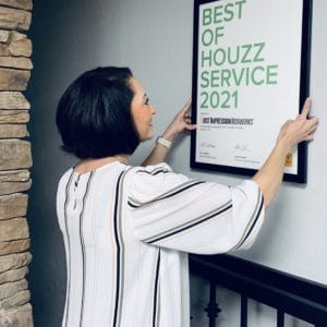 First Impression Ironworks employee hanging 2021 Best of Houzz Service Award on a wall