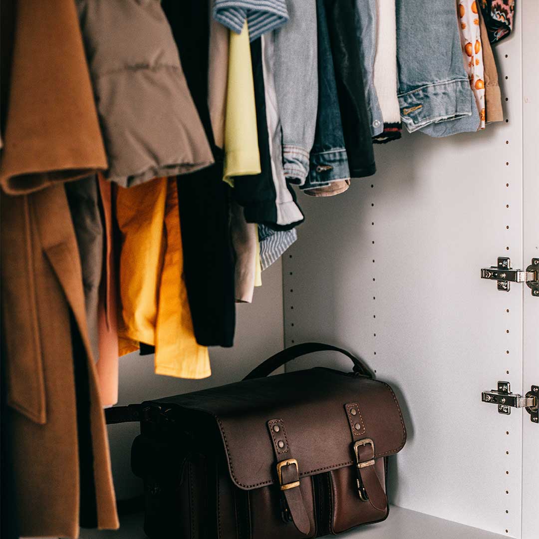 closet full of clothes and a bag