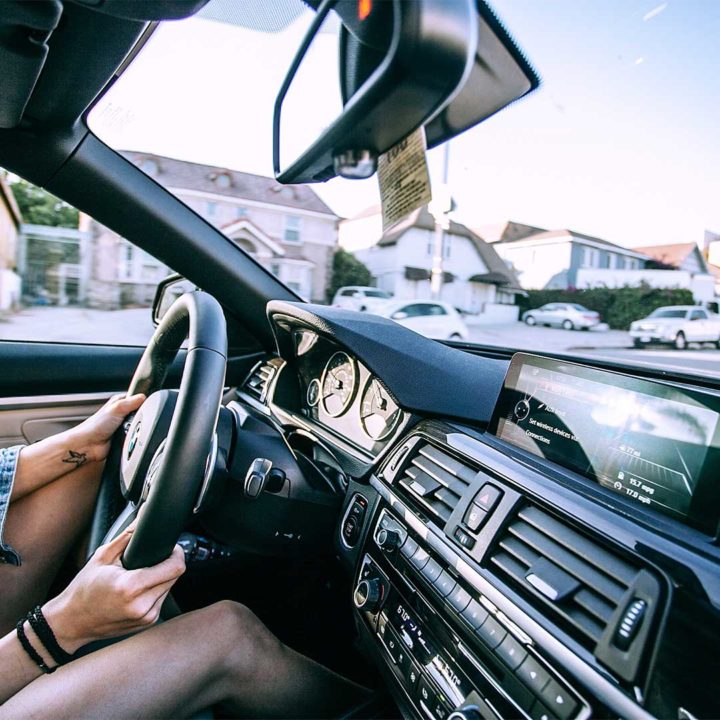 side view of someone driving a car