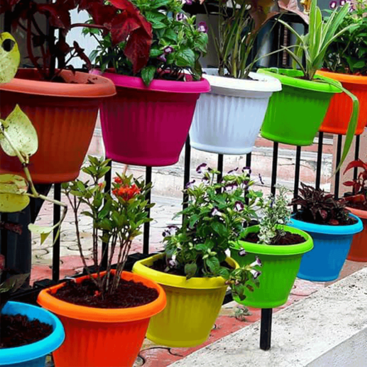 bright colored flower pots hanging on a fence