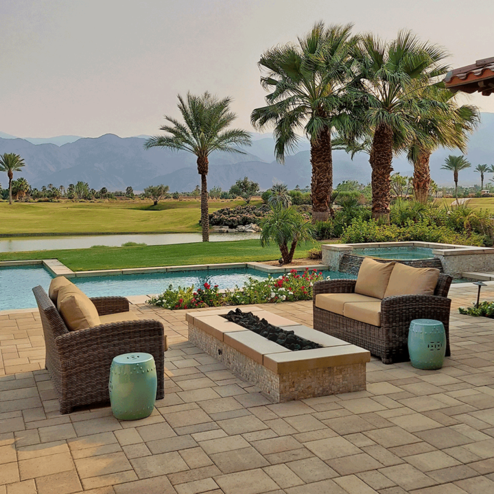 backyard with a fir pit and pool, overlooking a golf course