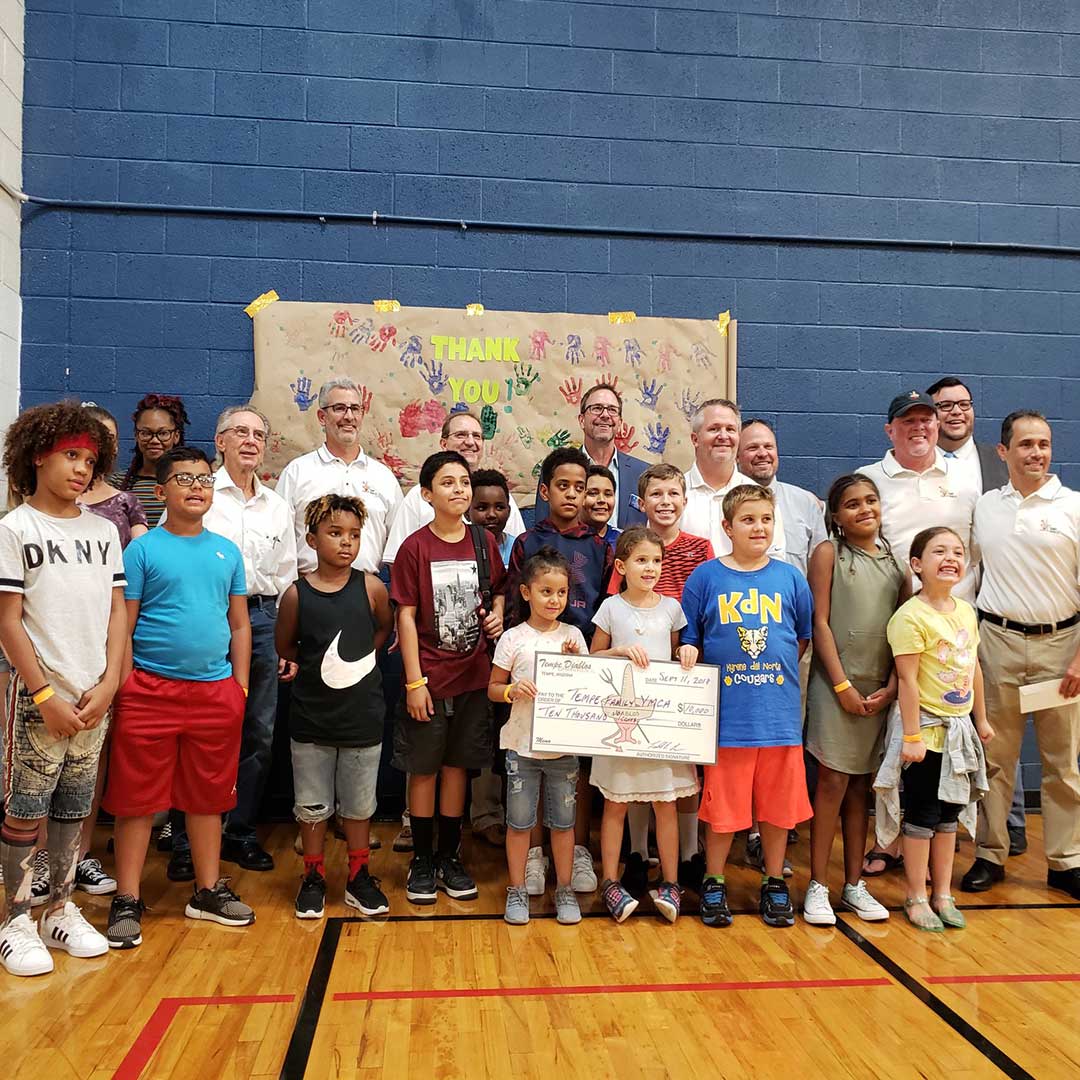 Tempe Diablos presenting a check to a school