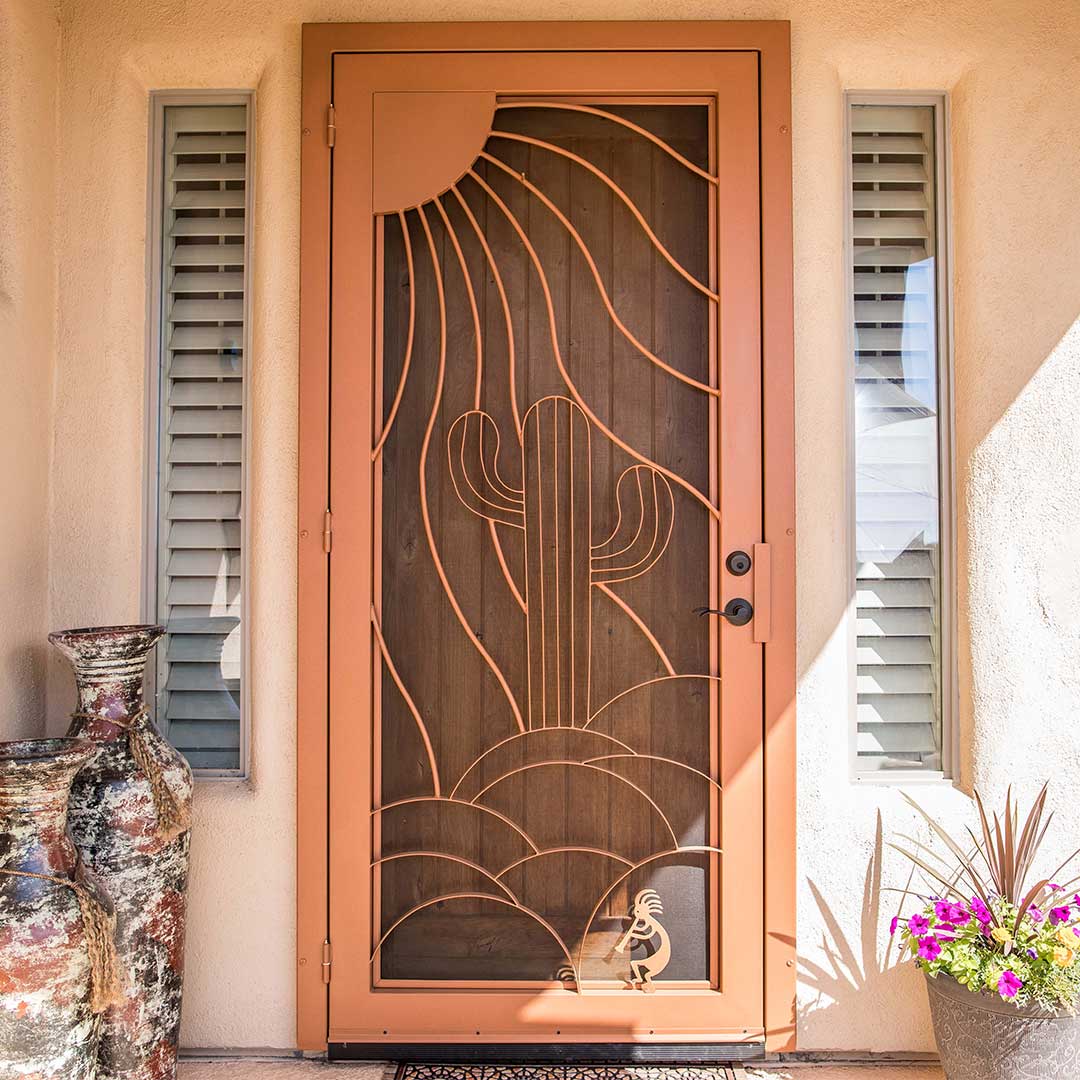 Iron security door with a sun and cactus design