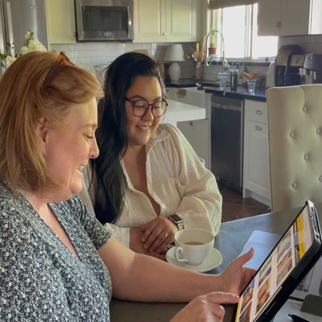 Two people looking at design options on a laptop