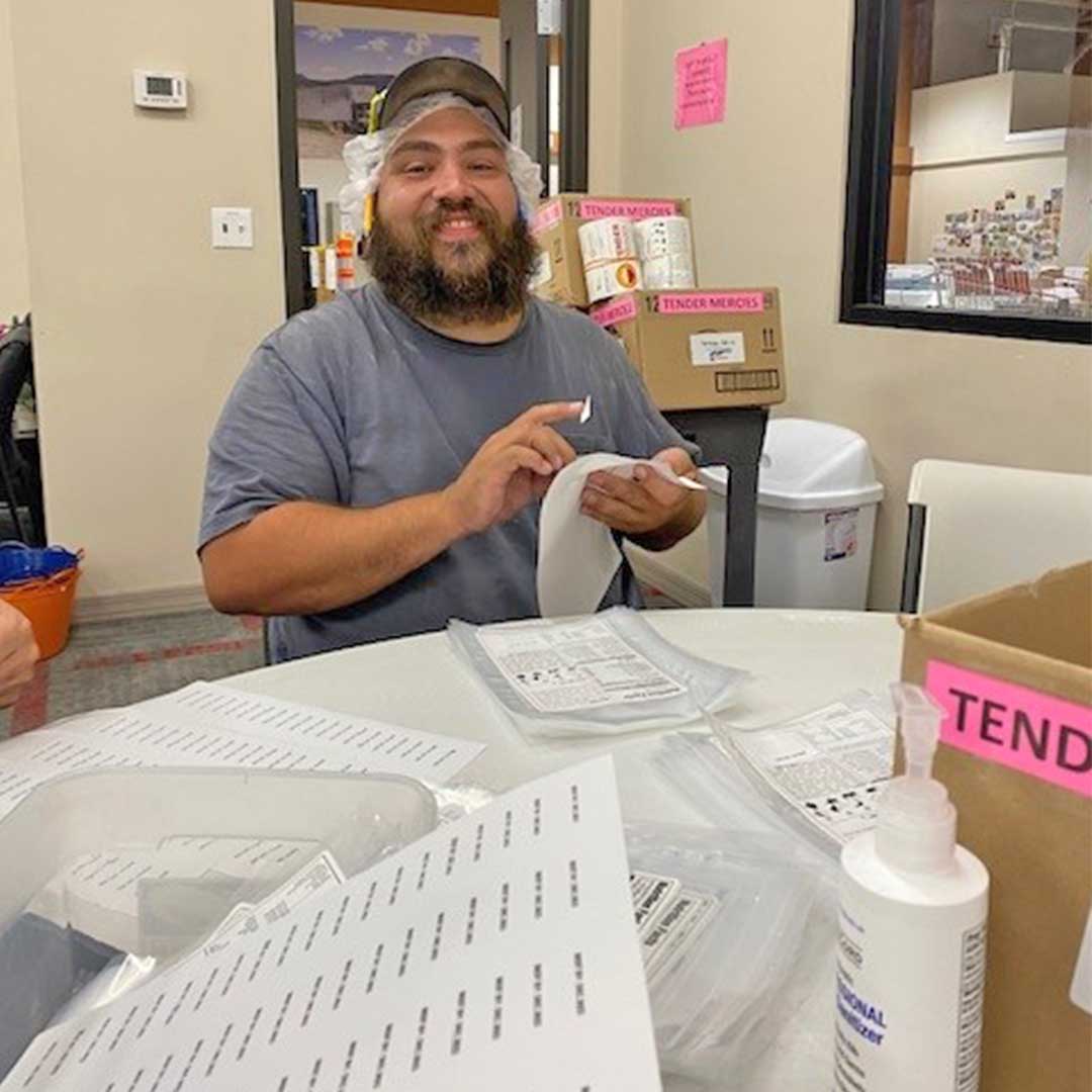 Male employee working with labels at Midwest Food Bank