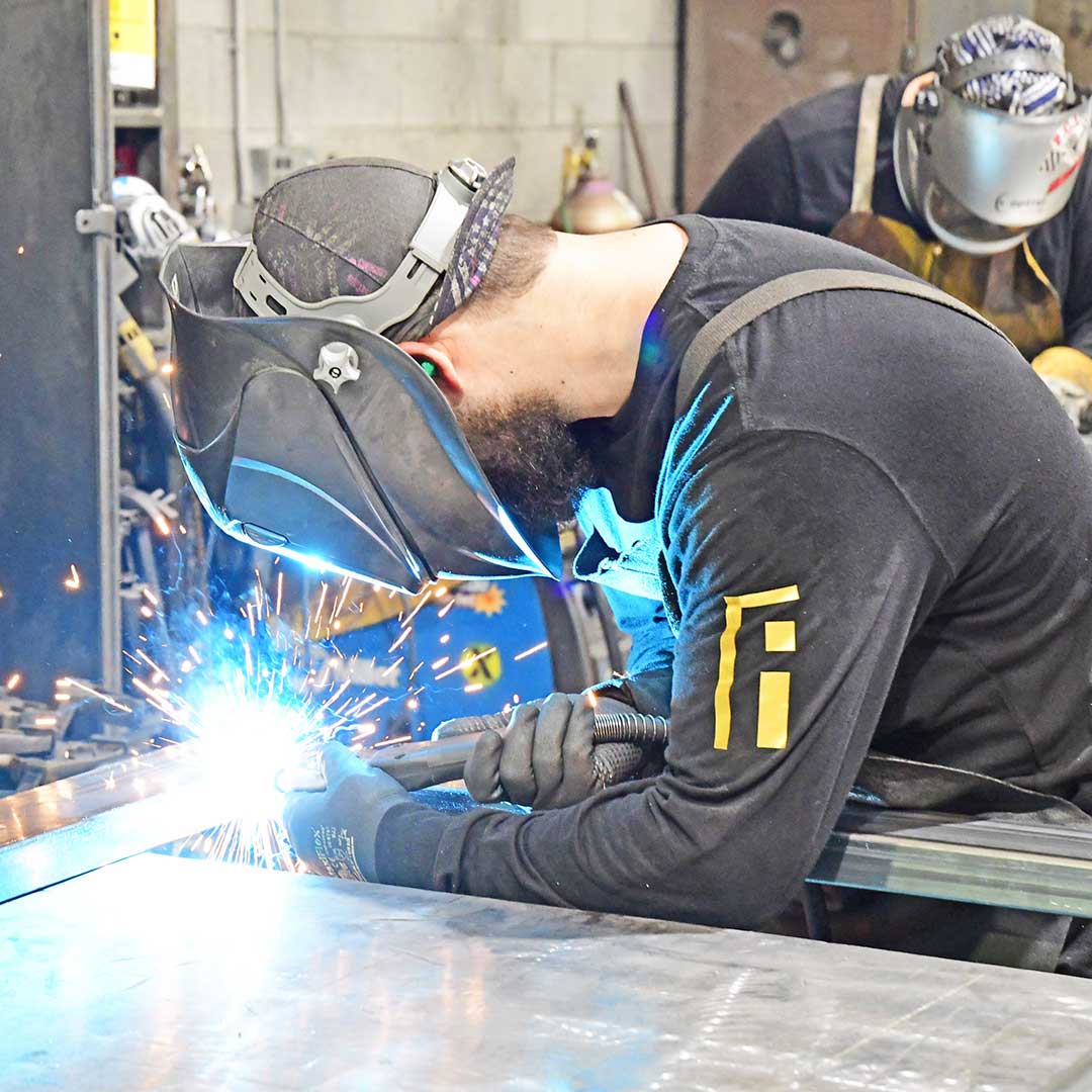 First Impression Ironworks employee welding an Iron Entry Door