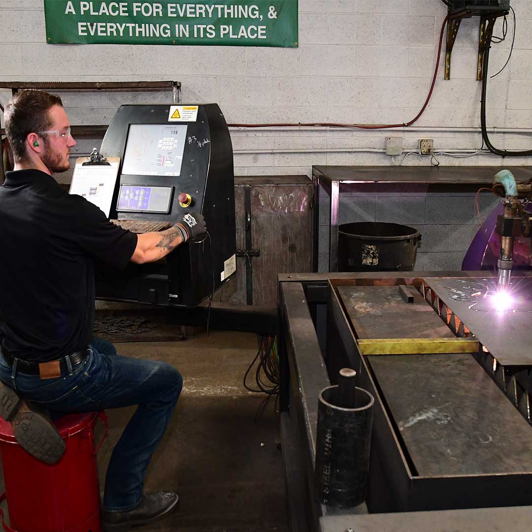 First Impression Ironworks employee operating plasma cutter machine 
