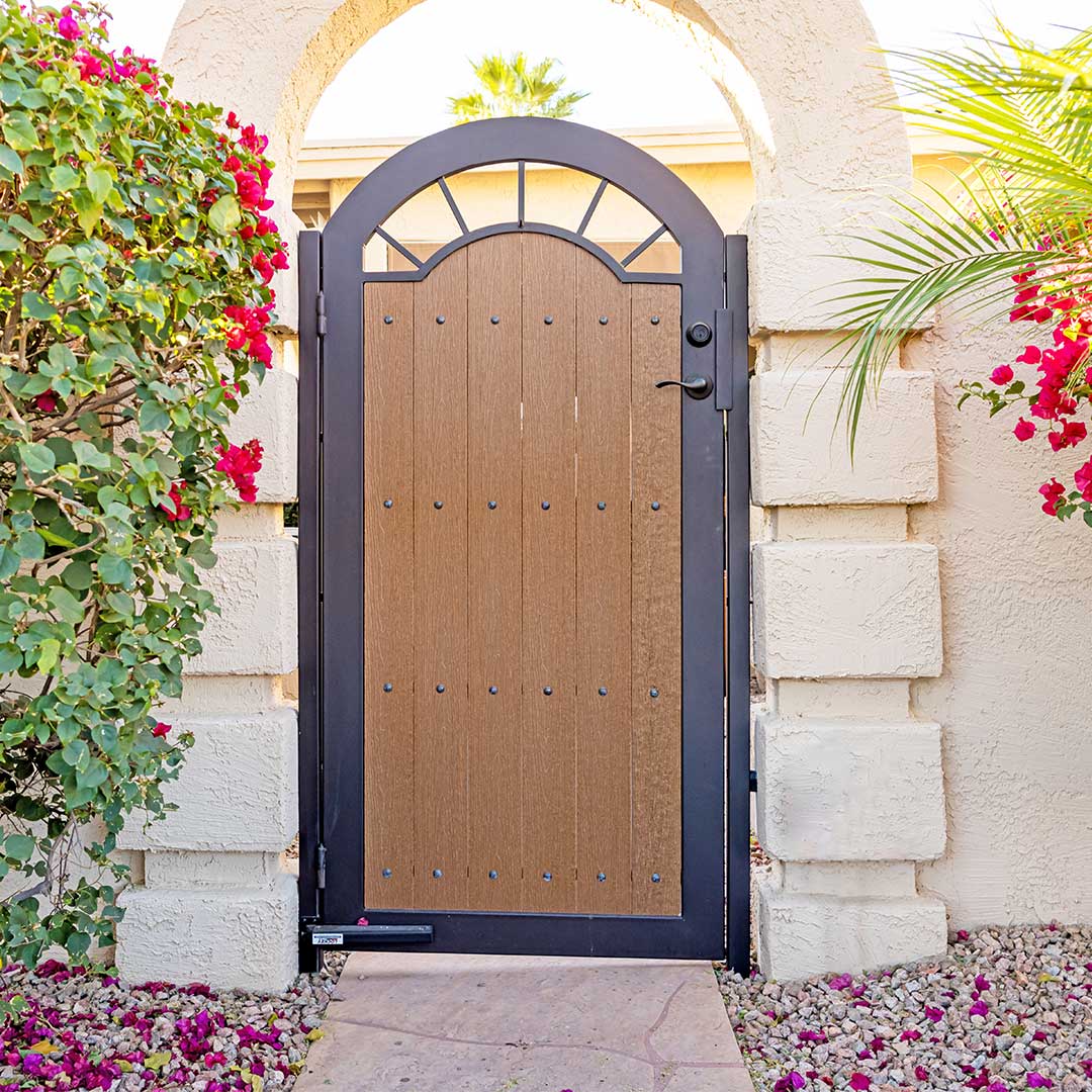 Composite wood and iron arched courtyard gate