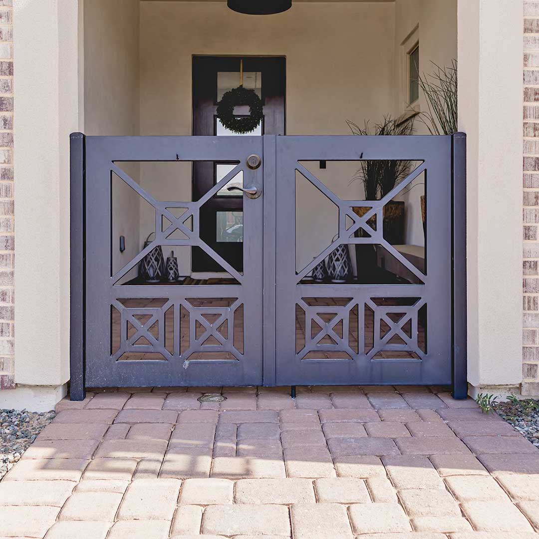 custom iron courtyard gate with a geometric pattern
