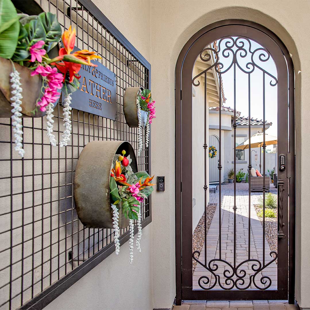 arched iron courtyard gate with intricate scroll designs 