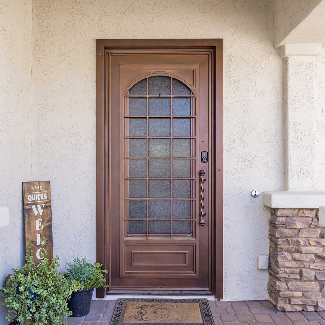 First Impression Ironworks iron entry door with an arch and grid design