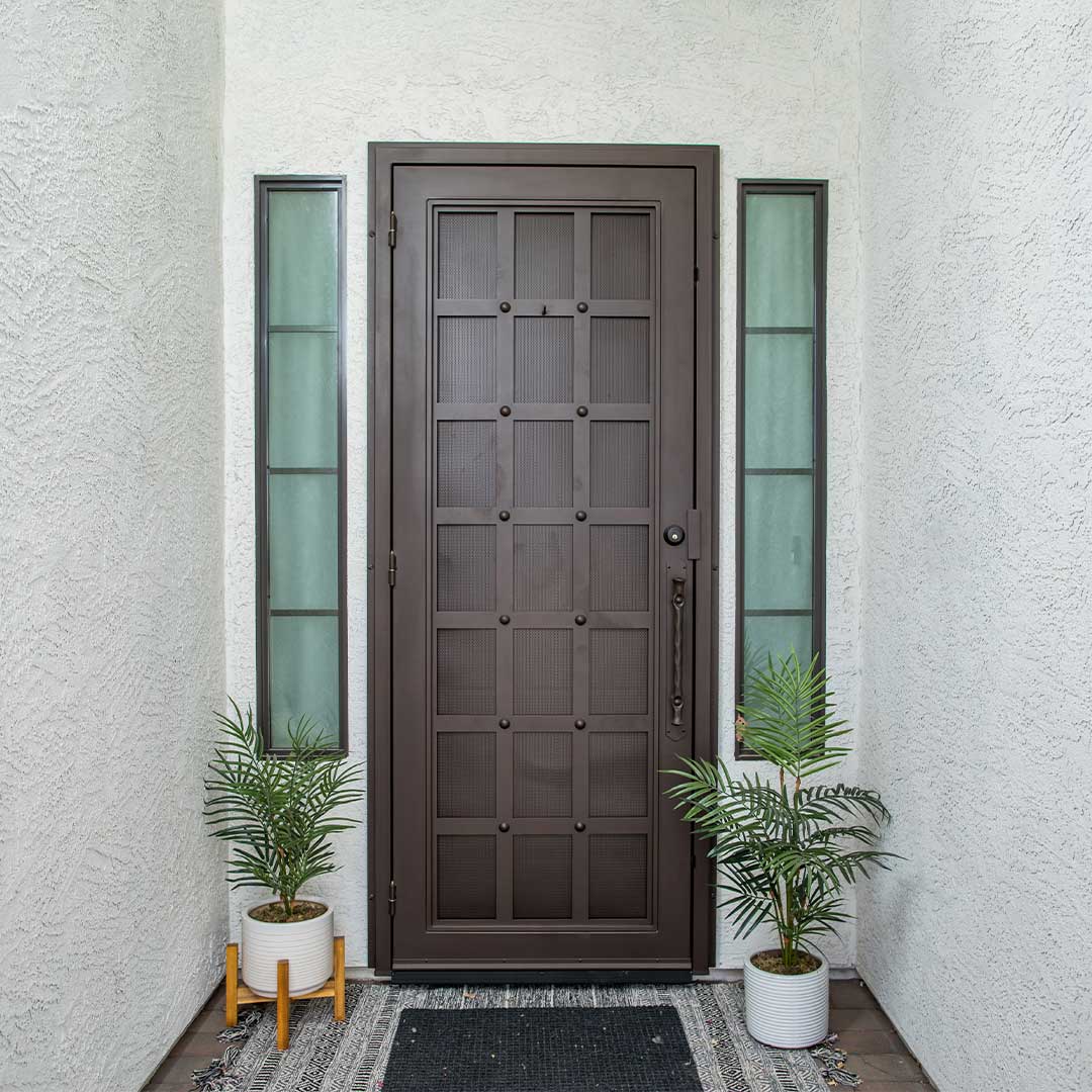 Dark brown First Impression Ironworks iron entry door a grid design