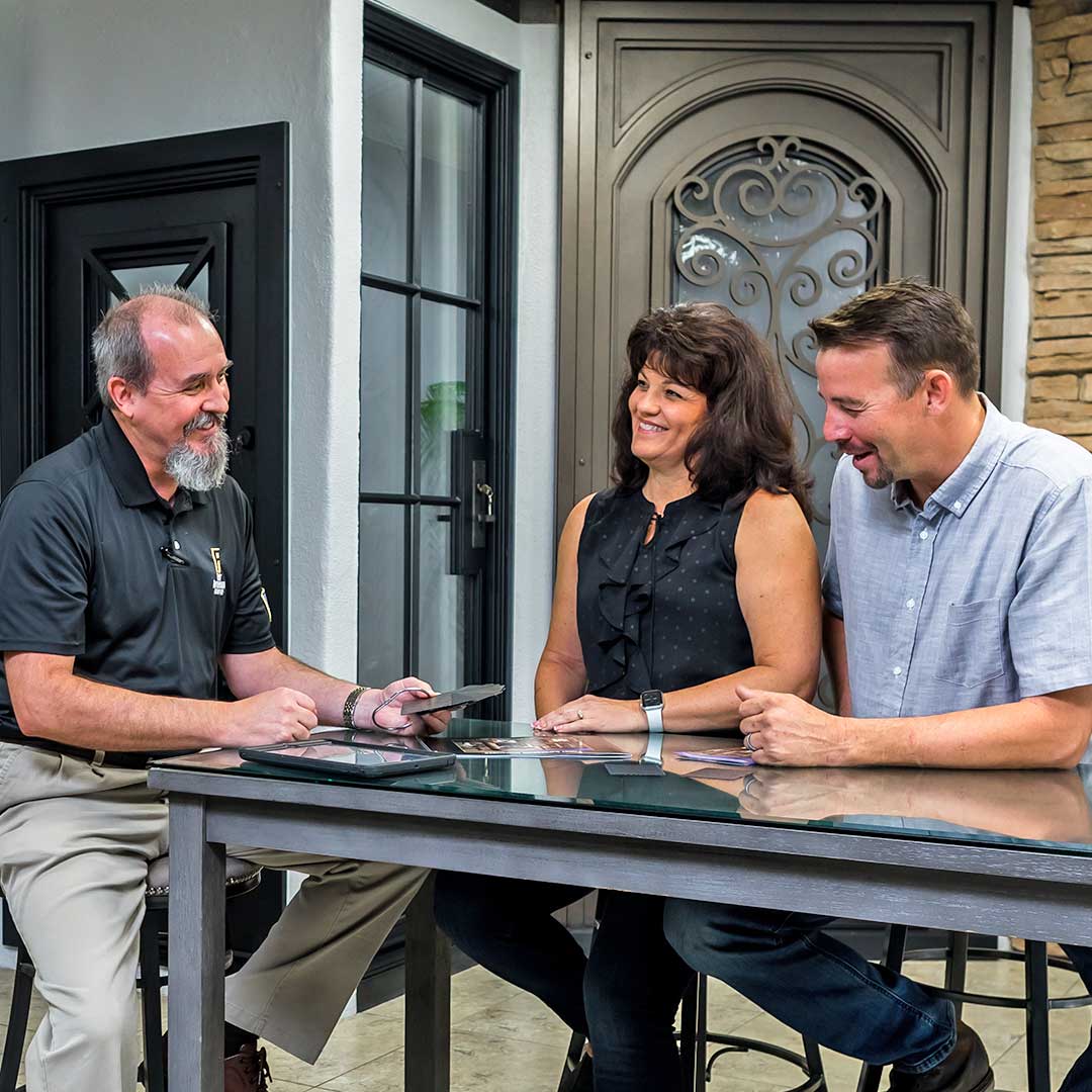 Man and woman sitting at a table with a First Impression Ironworks Design Consultant