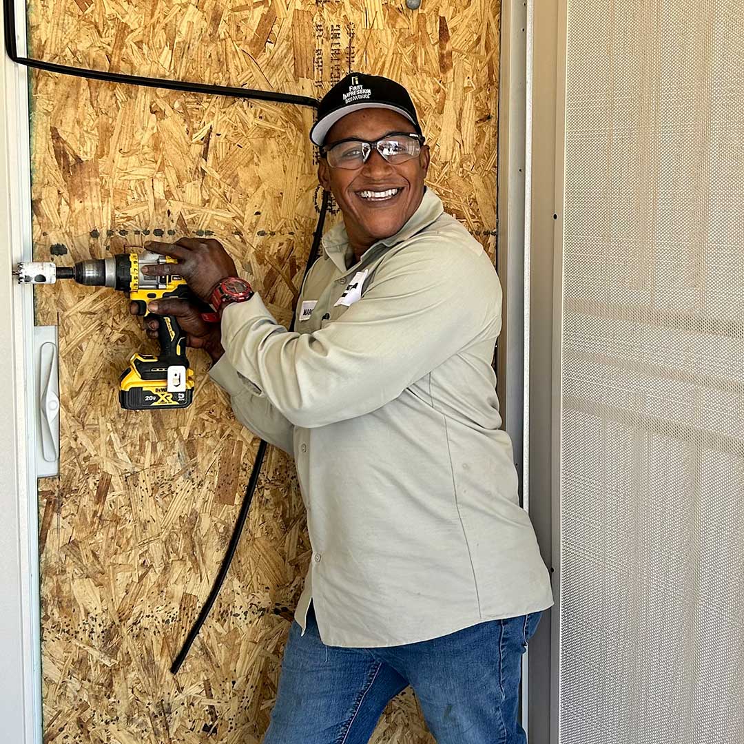 First Impression Ironworks employee installing a security door