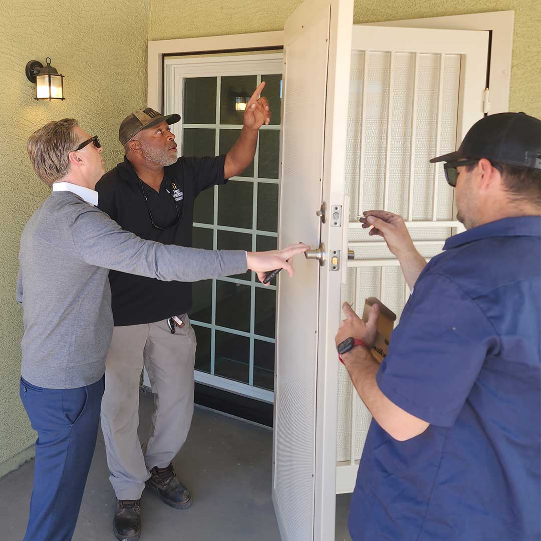 Iron security door inspection at a Habitat for Humanity home