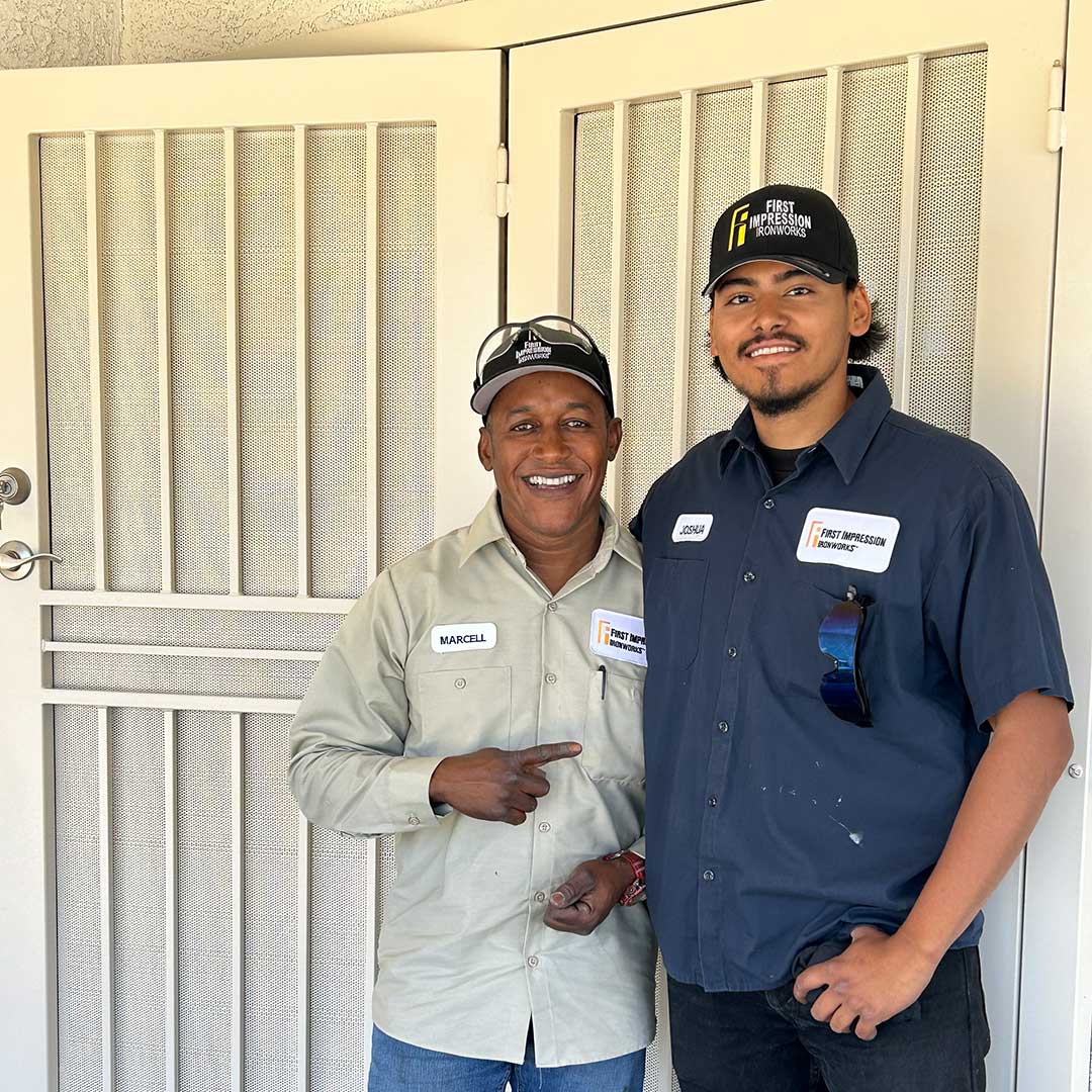 First Impression Ironworks installation volunteers standing in front of the iron security door