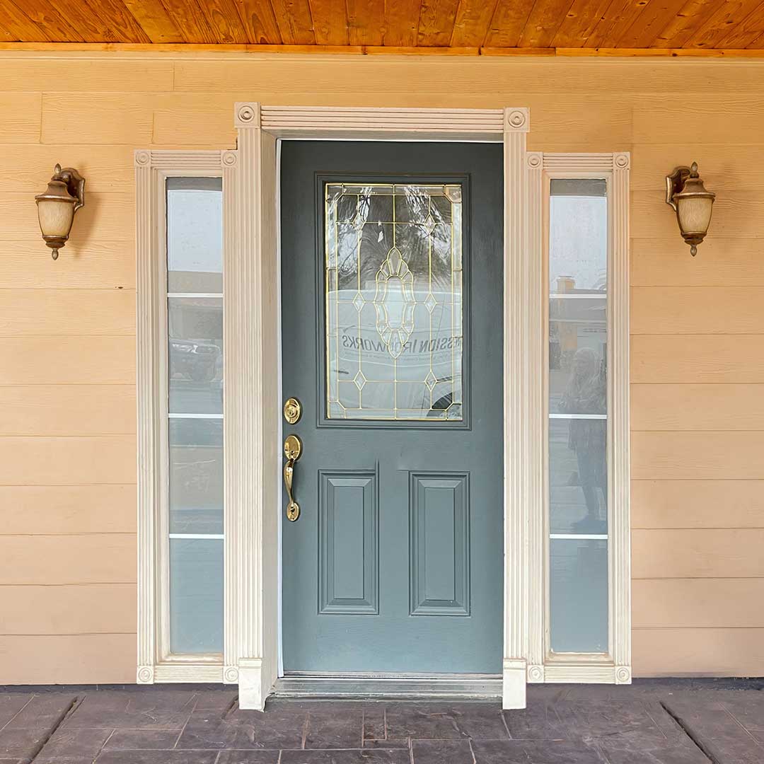 Before image of a wooden front door with sidelights