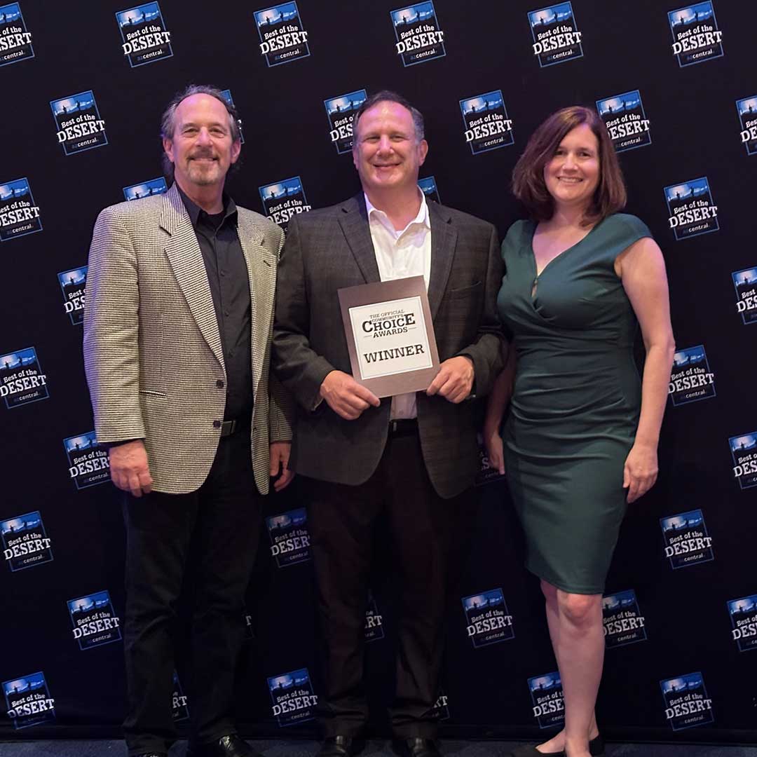 First Impression Ironworks CEO holding 2023 Best of Desert winner plaque with two other employees