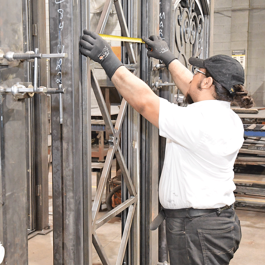 First Impression Ironworks employee measuring a door