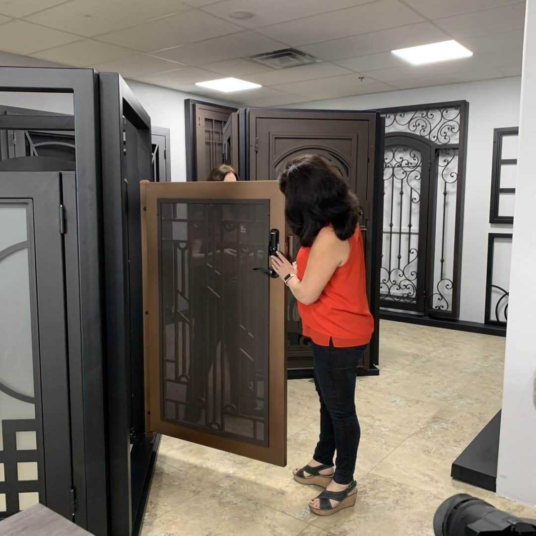 A Homeowner browsing doors in a First Impression Ironworks showroom
