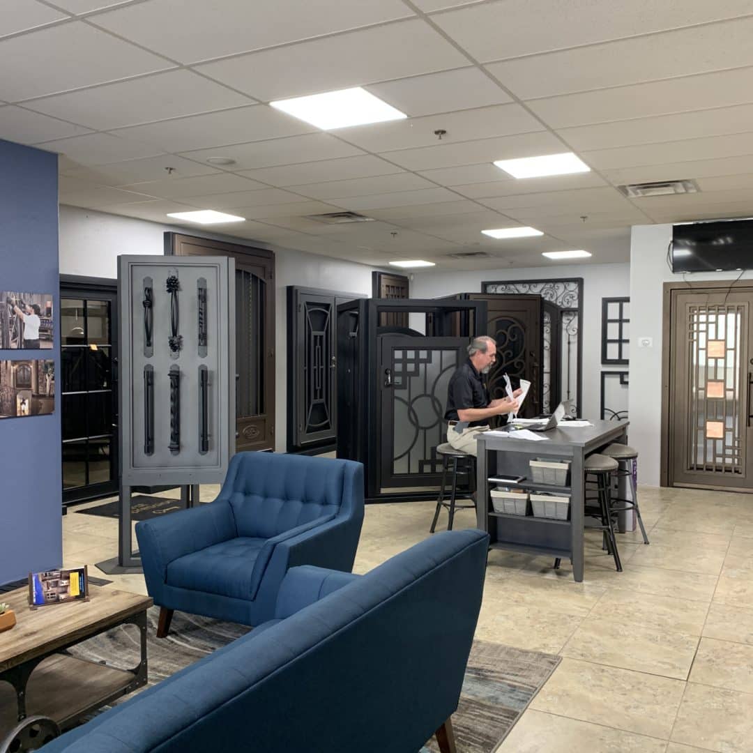 First Impression Ironworks Design Specialist working at a desk in a First Impression Ironworks showroom