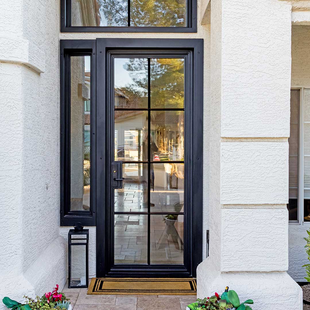 Single modern glass and black iron entry door by First Impression Ironworks