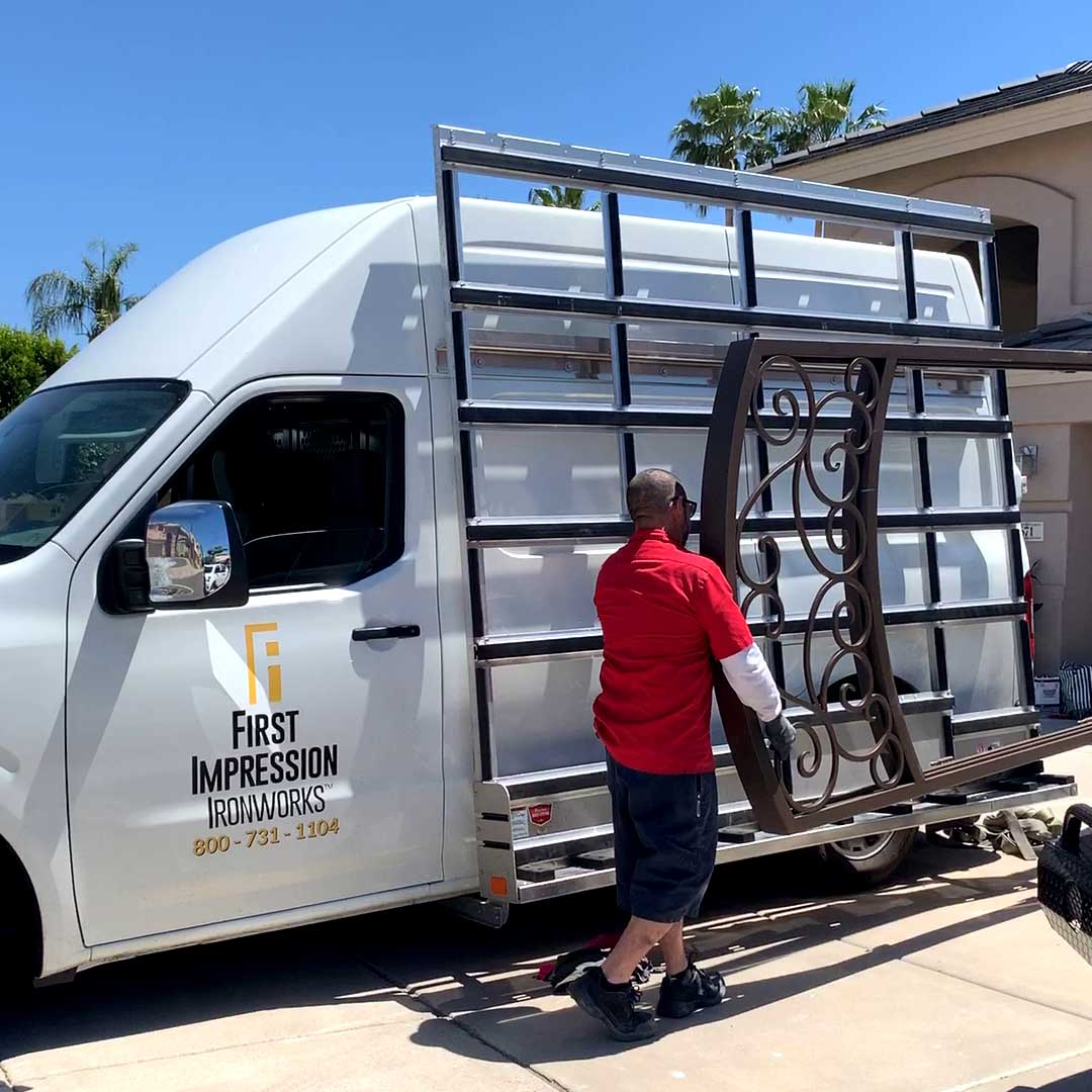 First Impression Ironworks installer unloading a Iron Entry Door off of a First Impression Ironworks van