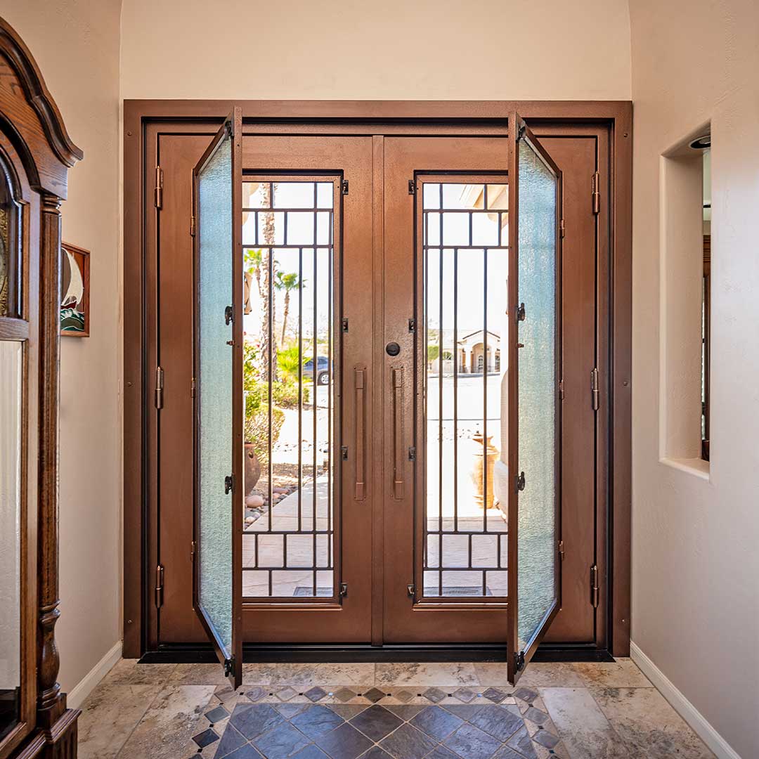 French iron and glass iron entry door with glass panels that open to allow airflow, by First Impression Ironworks