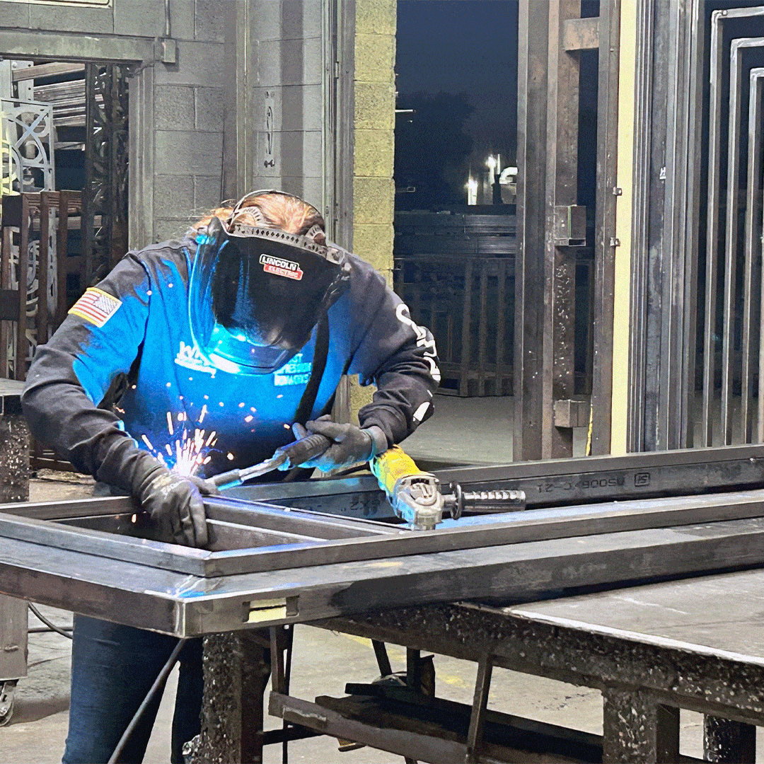 First Impression Ironworks welder working on a custom iron door