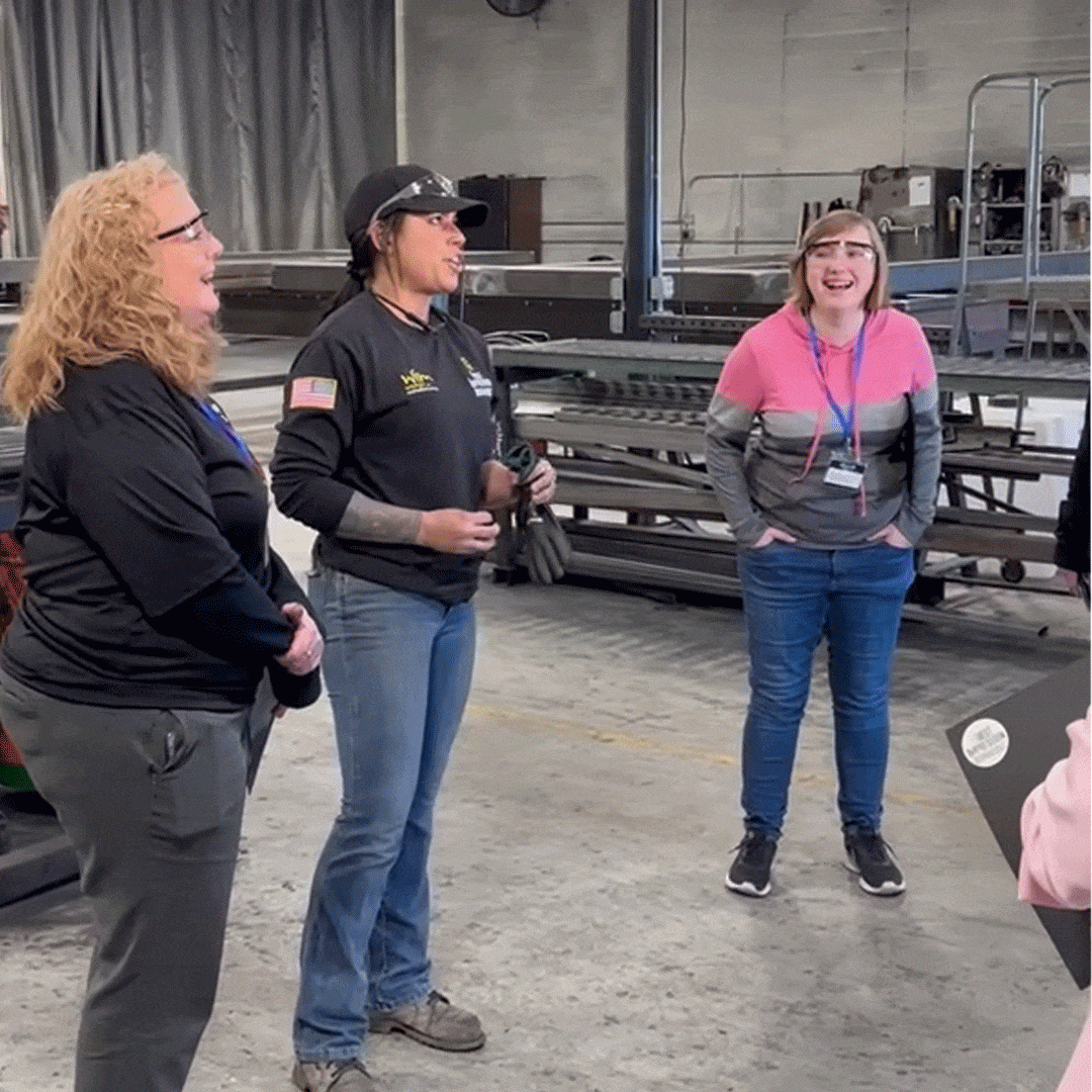 Women in Manufacturing members speaking with First Impression Ironworks employees
