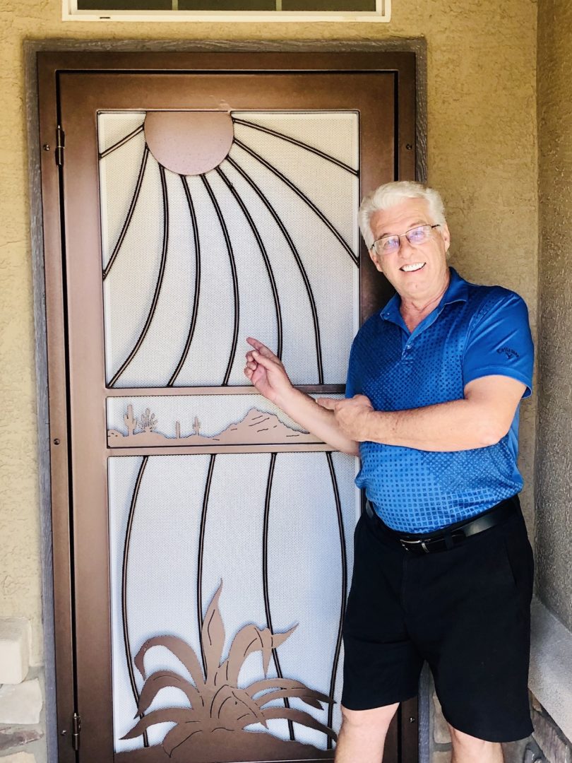 First Impression Ironworks homeowner standing proud next to his new iron security door