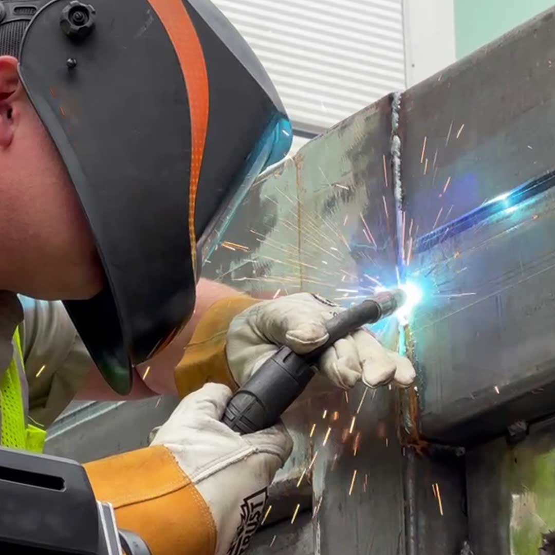 Close up of a welder working on a custom iron product