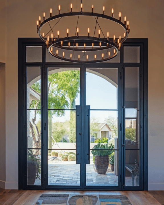 Modern black iron and glass iron entry door designed by First Impression Ironworks