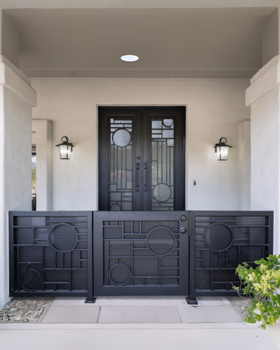 Matching custom iron entry door and courtyard gate designed by First Impression Ironworks