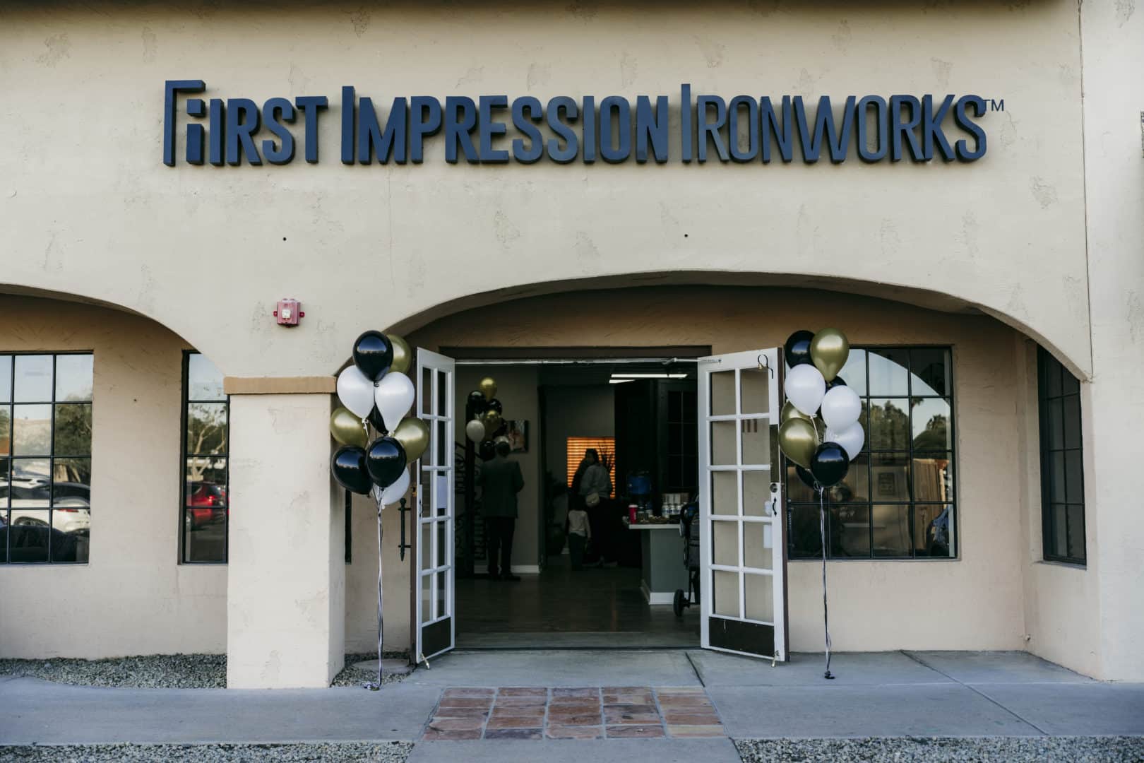 Entrance of the Scottsdale First Impression Ironworks showroom decorated with balloons for a gathering