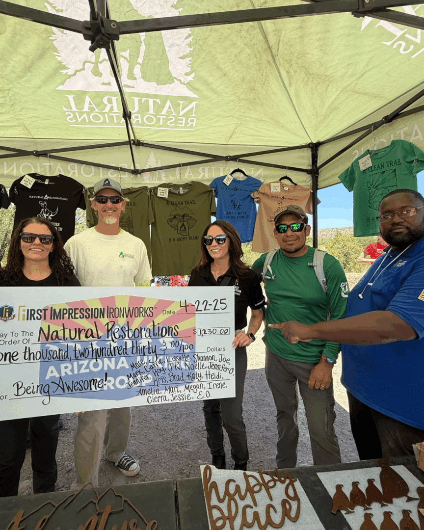 First Impression Ironworks presenting Natural Resources an oversized donation check
