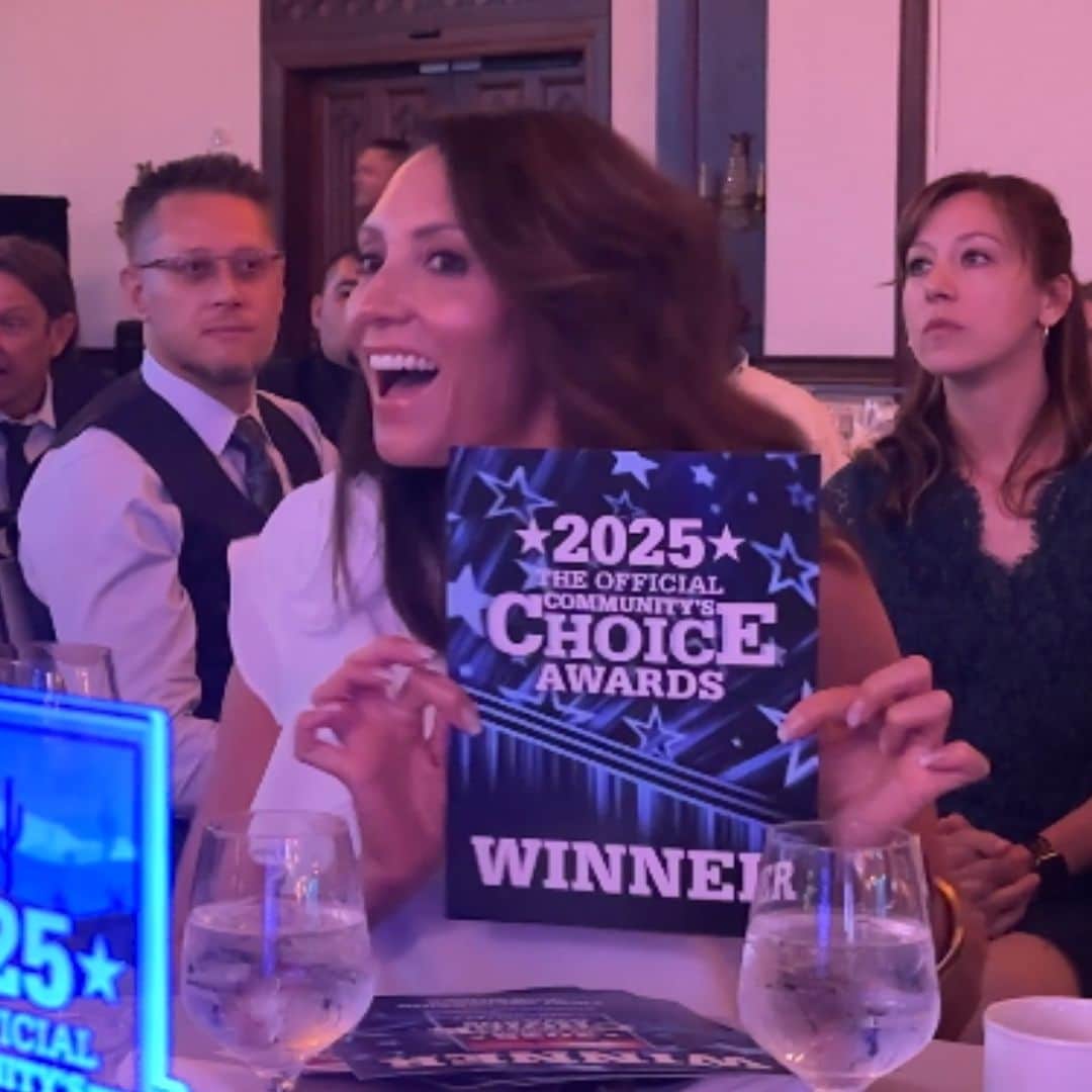 Director of Customer Care holding a sign designating First Impression Ironworks the winner of Best of the Desert