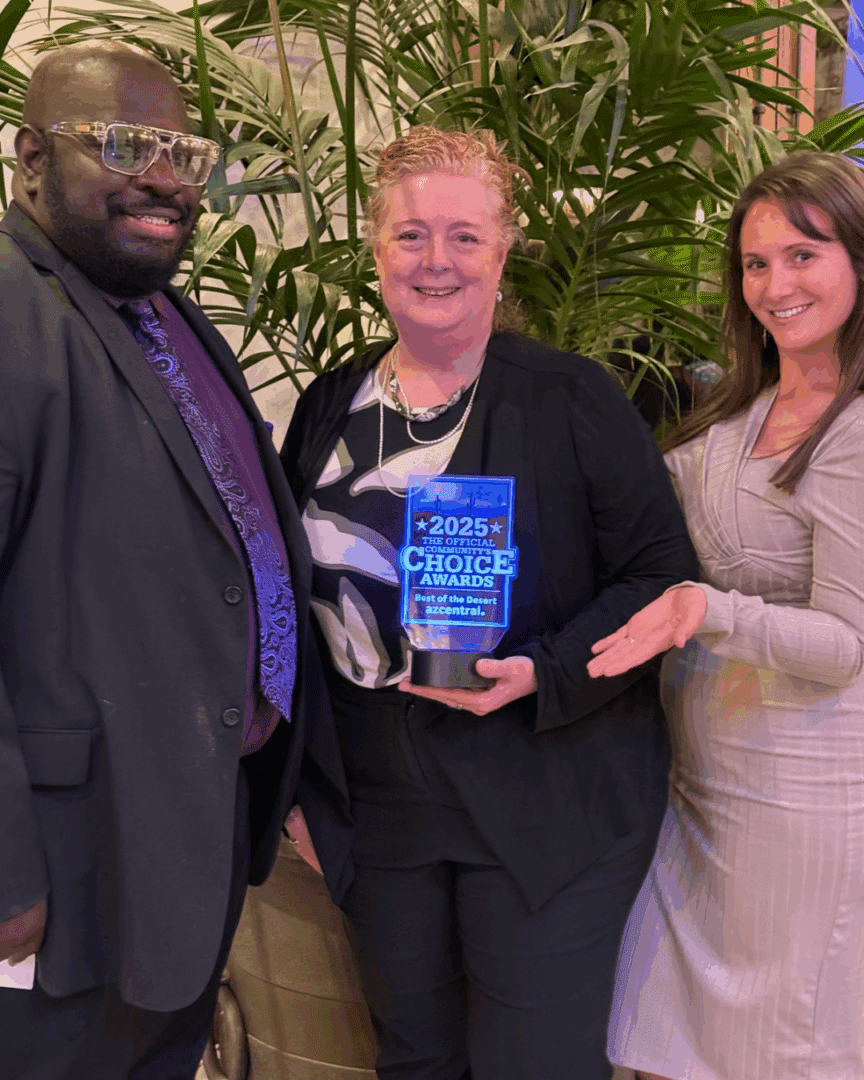 Three First ImpressionIronworks team members holding the Best of the Desert award