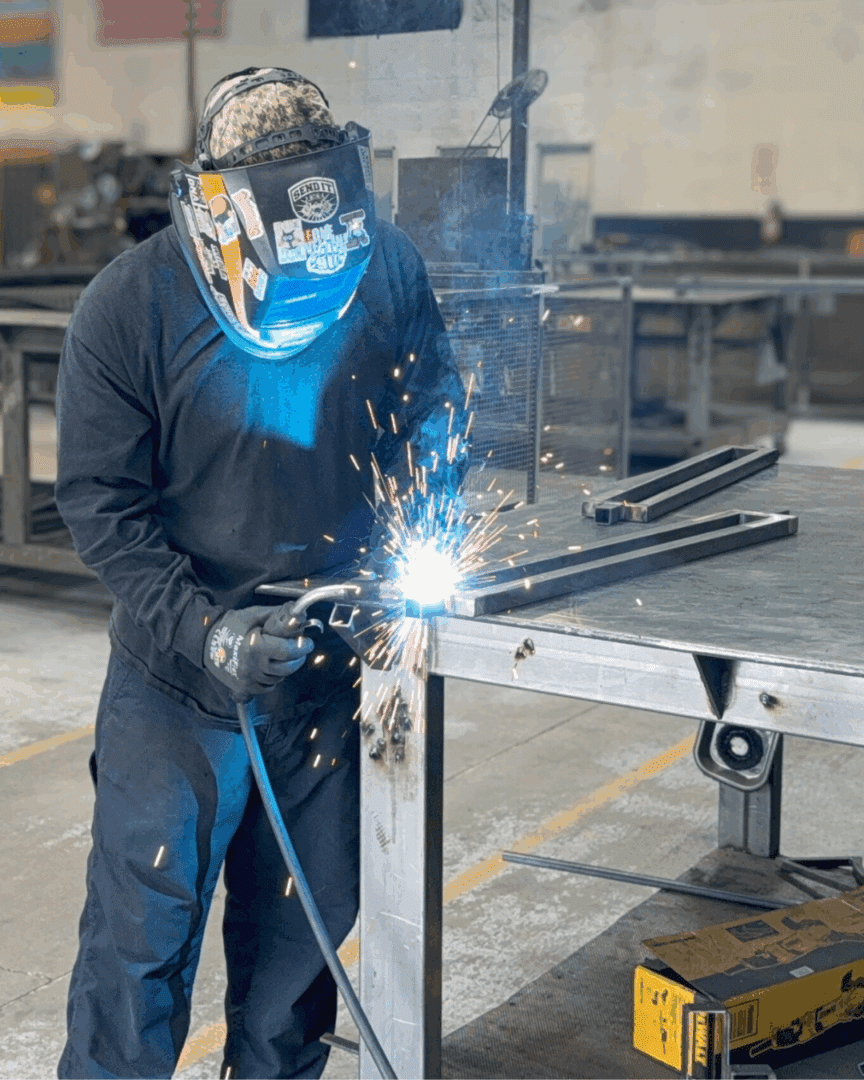 First Impression Ironworks welder working on a custom iron railing