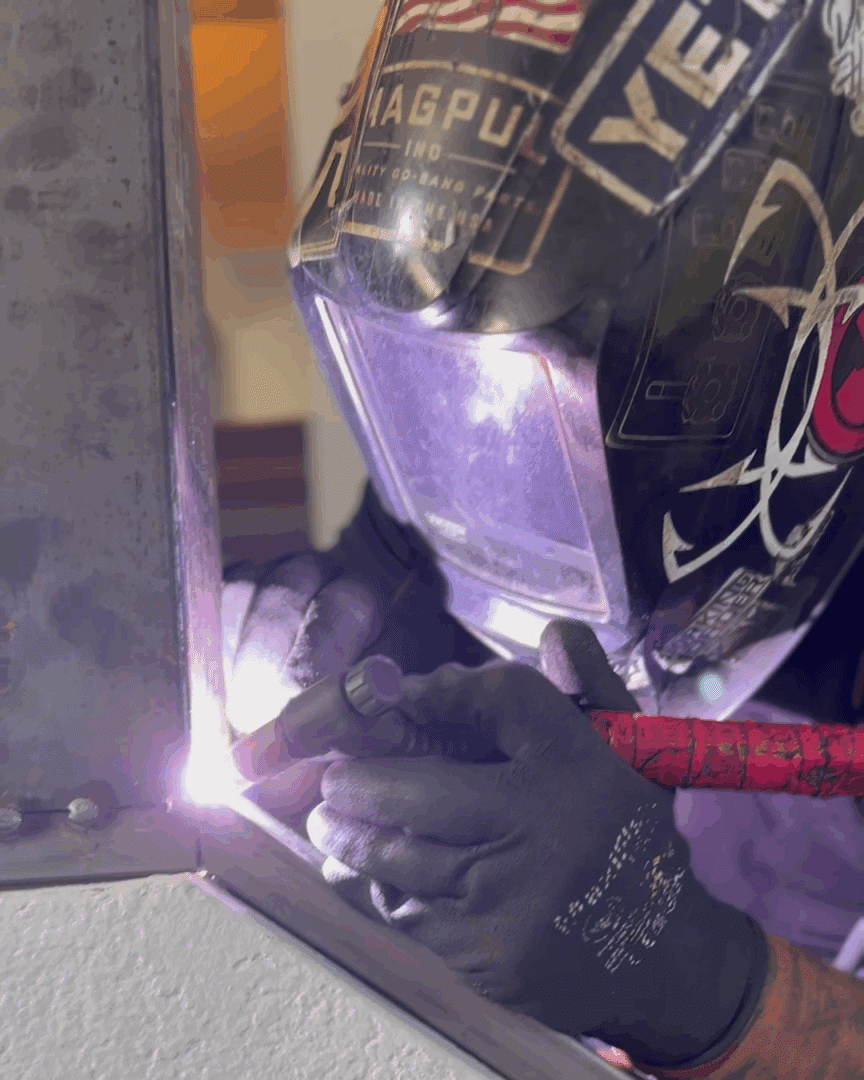 Close up of a First Impression Ironworks employee welding the iron staircase mock up